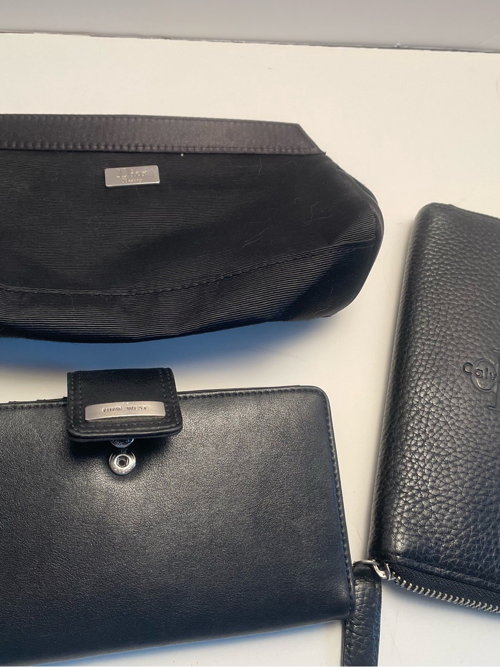 Woman’s bundle: Dior cosmetic bag;Nine West and Calvin Klein wallet